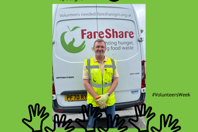 Photo shows Nick, one of our volunteer drivers wearing a hi viz vest, standing behind a FareShare Greater Manchester delivery van