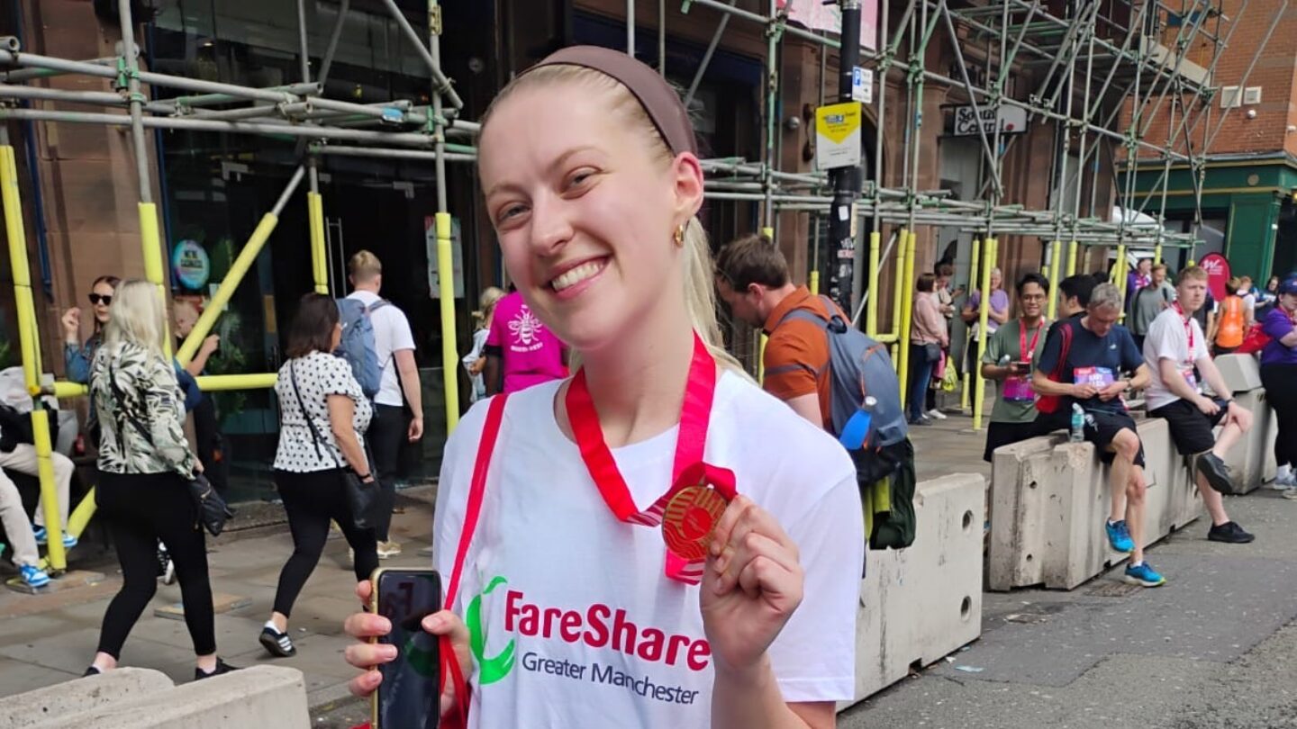 Former volunteer, Isobel, with her race medal after running in the Great Manchester Run 10K