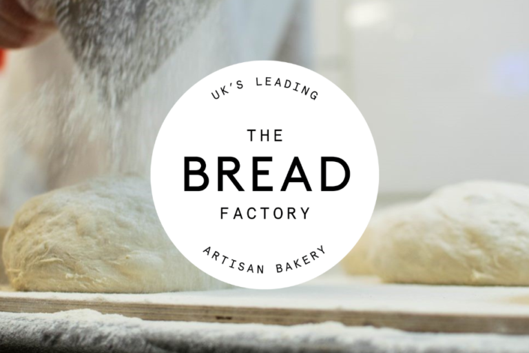 baker flouring dough with The Bread Factory logo