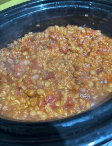 Image shows a cooked lentil dahl in a slow cooker