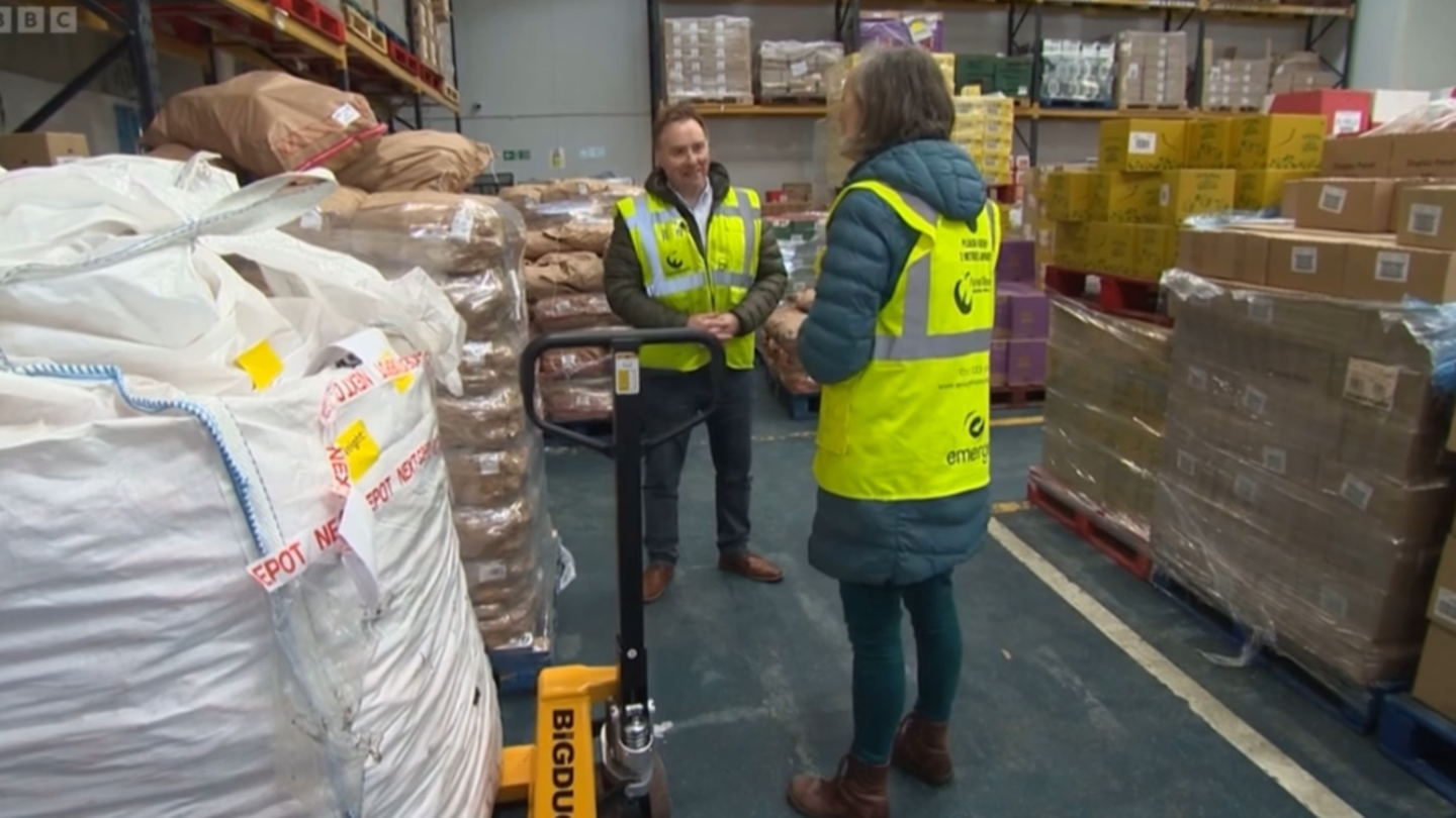 Image shows our Chief Executive Lucy Danger being interviewed by BBC North West Tonight reporter Phil Cunliffe in our warehouse