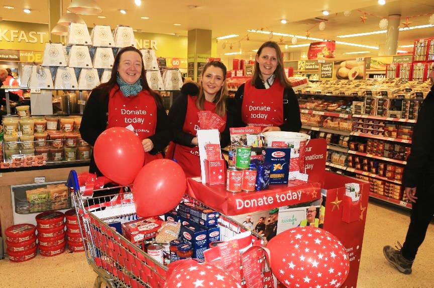 Tesco food volunteers trio in store