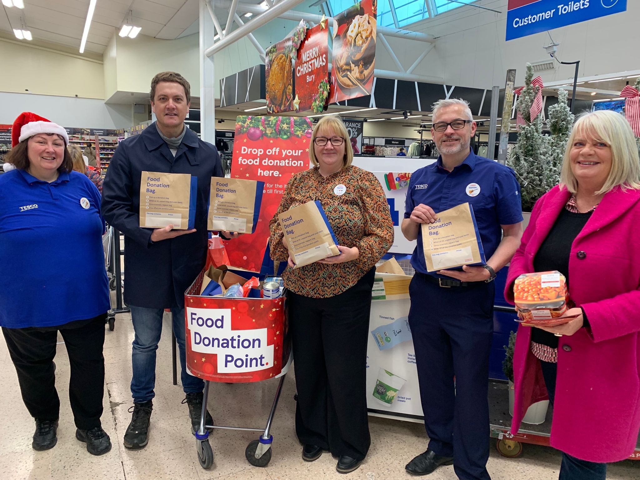 Image shows Tesco Food Collection group photo with volunteers and staff from Tesco in November 2024
