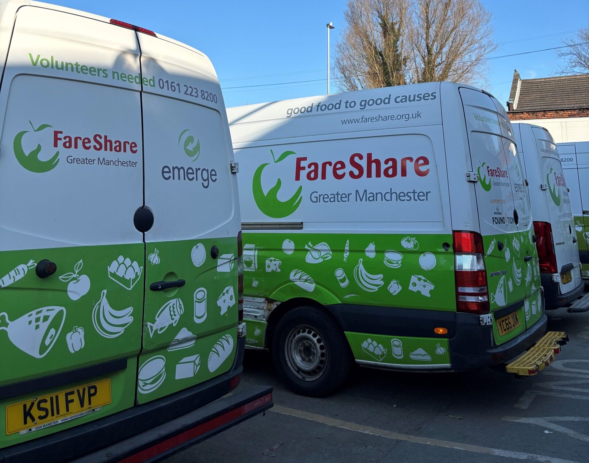 Image shows a row of FareShare Greater Manchester vans parked in a row